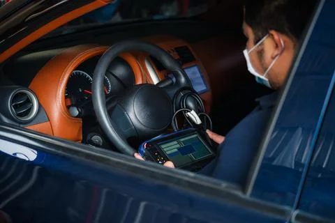 Checking a car engine OBD for repair at car garage Foto stock