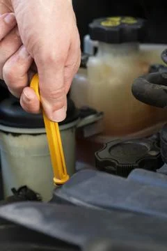 Checking Car Engine Oil with Dipstick Stockfoto's