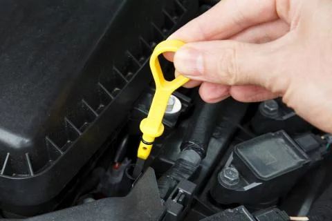 Checking car engine oil Stock Photos