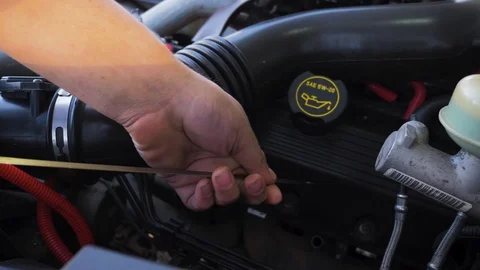 Checking car engine oil pulling stick with hands close up Vídeo Stock 107609609