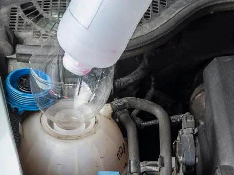 Checking car radiator coolant level and add up liqiud. Stock Photos