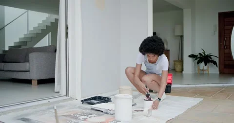 Checking chips and cans African woman in overalls testing swatch picking hue at Stock Footage 339162742