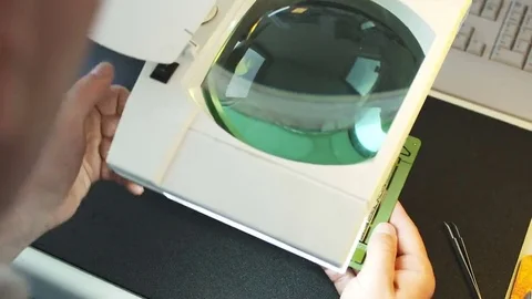 Checking circuit board under magnifying glass Stock Footage 69166680