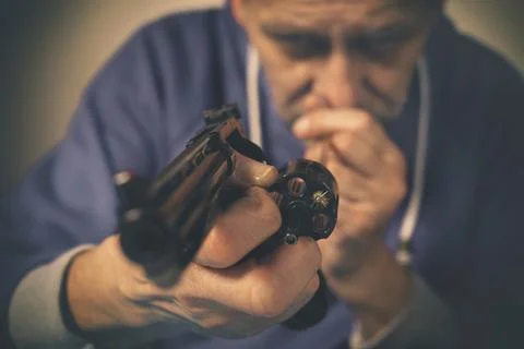 Checking, cleaning and loading of black finished .357 magnum revolver handgun Stock Photos