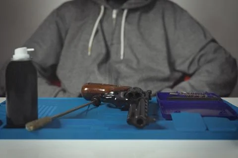 Checking, cleaning and loading of black finished .357 magnum revolver handgun Stock Photos