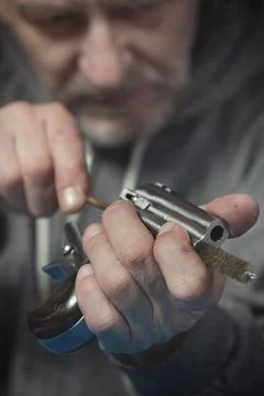 Checking, cleaning and loading of small derringer .38 special handgun by man Stock Photos