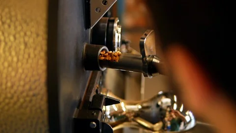 Checking coffee beans in a roaster Stock Footage 129401080