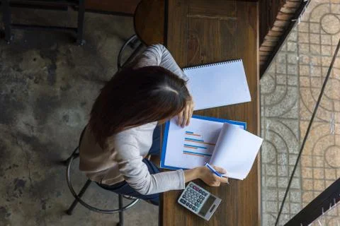 Checking the column report and take note important number Stock Photos