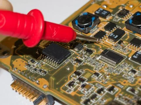 Checking the components of the laptop motherboard with a multimeter Stock Photos