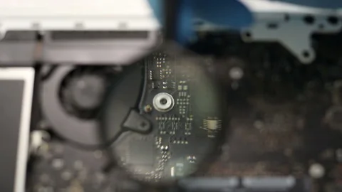 Checking computer mainboard with magnifying glass. Stock-Footage 91795051