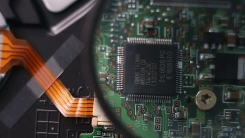 Checking computer mainboard with magnifying glass. Stock Footage 91885376