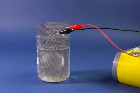 Checking the conductivity of the substance. Anode and cathode in Stock Photos