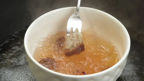 Checking Cooked Swiftlet Bird Nest Strands With Fork In Steaming Bowl Vídeos de archivo 339406823
