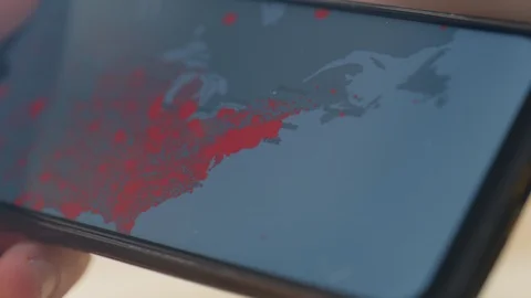 Checking coronavirus epidemic status in mobile phone at home Stock Footage 128240607