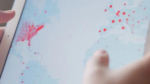 Checking coronavirus epidemic status in mobile phone at home Stock Footage 128241644