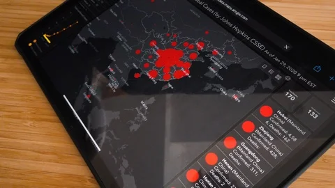 Checking Coronavirus Infos on iPad Stock Footage 123946931
