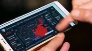 Checking Coronavirus Pandemic Status On Smartphone App Stock Footage
