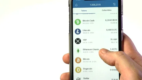 Checking  cryptocurrency price  on smartphone.Stock exchange. Stock Footage 166019266