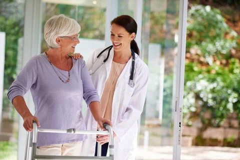 Checking up on the daily progress. Shot of a senior woman using an orthopedic 写真素材