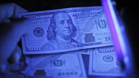 Checking Dollar Bill Authenticity Under UV Light Stock Footage 319040253