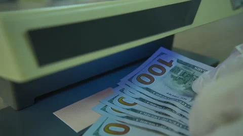 Checking Dollars Banknotes on Currency Detector Stock Footage 307755781