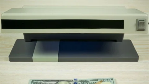 Checking the dollars in the currency detector. Stop motion Video stock 79038392