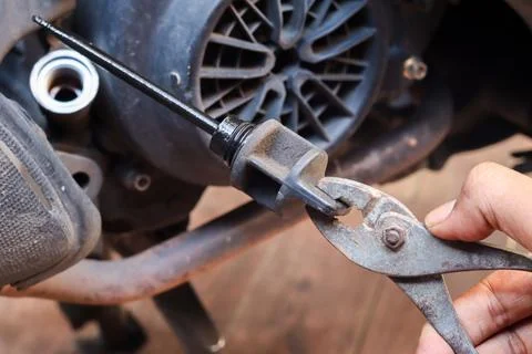 Checking the engine oil level and condition Stock Photos