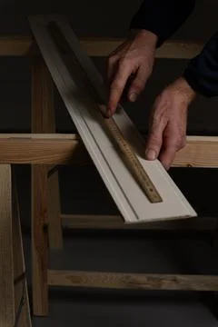 Checking exact measurement on decorative wall panel board before cutting Stock Photos