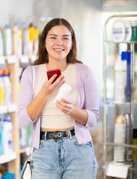Checking expiration date of body deodorant - female shopper scans QR code on Stock-Fotos