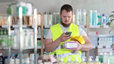 Checking expiration date of feminine pads - male builder scans QR code on label Stock Footage 319995957
