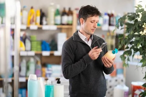 Checking expiration date of liquid hand soap - shopper scans QR code on label of 스톡 사진