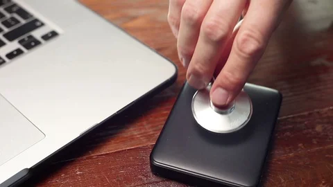 Checking external hard disk with stethoscope. Stock Footage 91832995