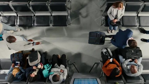 Checking flight status information and travelers in airport, top down view Stock Footage 334782077