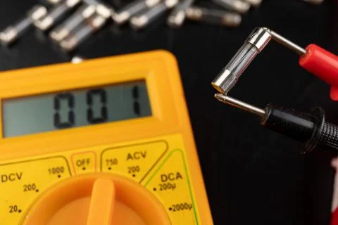 Checking glass fuses using the meter. Simple electrical work in a home worksh 写真素材