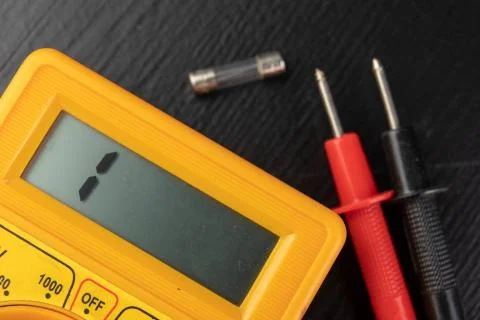 Checking glass fuses using the meter. Simple electrical work in a home worksh Stock Photos