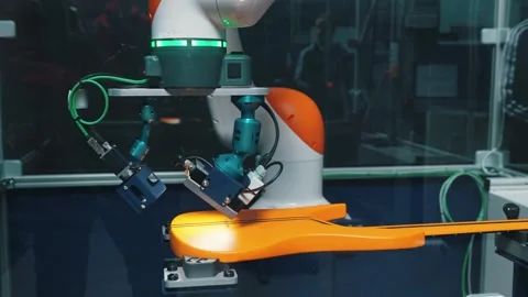 Checking the guitar, robot arm working on the yellow modern guitar at the 库存影片 274473813