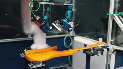 Checking the guitar, robot arm working on the yellow modern guitar at the 库存影片 274763257