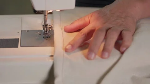 Checking a handmade stitching line on linen fabric by hand Stock-Footage 345456539