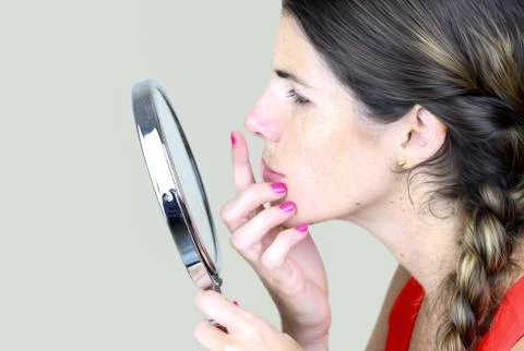 Checking herelf in the mirror Stock Photos