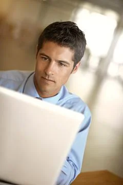 Checking his emails. a businessman using his laptop in the office. 스톡 사진
