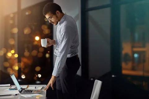 Checking his emails on a coffee break. a businessman using a laptop while woking Stock Photos