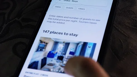 Checking hotel rooms in Dubai - Using the Airbnb app - Exploring Dubai Stock Footage 113931147