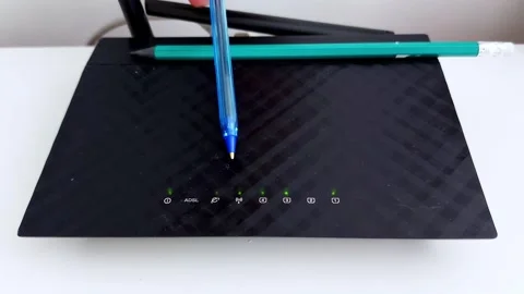 Checking Internet Router Lights with Pen and Pencil on Top-Closeup Stock Footage 312313959