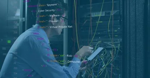 Checking IT tech reading tablet in server room with racks, switches and colorful Foto stock