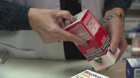 Checking labels for medicine at pharmacy Stock Footage 58063154