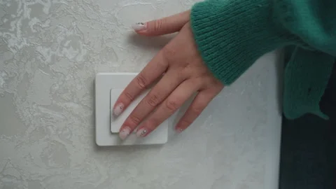 Checking light switch during movein. Closeup of fingers pressing switch in new Vidéo 337229781