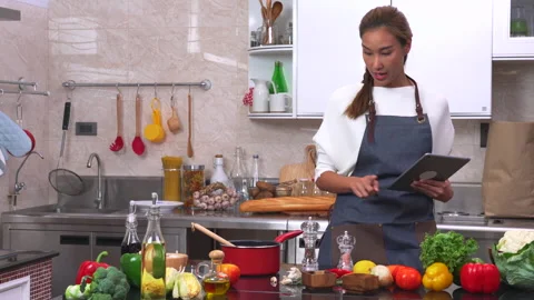 Checking list of vegetables and ingredients for cooking in the kitchen. Stock Footage 134414026