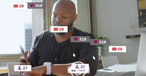 Checking man in dark henley holding phone and glancing at white smartwatch at Stock Photos