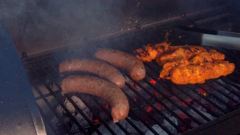 Checking the Meat on the BBQ. This summer there is nothing better to have Stock Footage 108463721