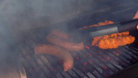 Checking the Meat on the BBQ. This summer there is nothing better to have Stock Footage 108463781